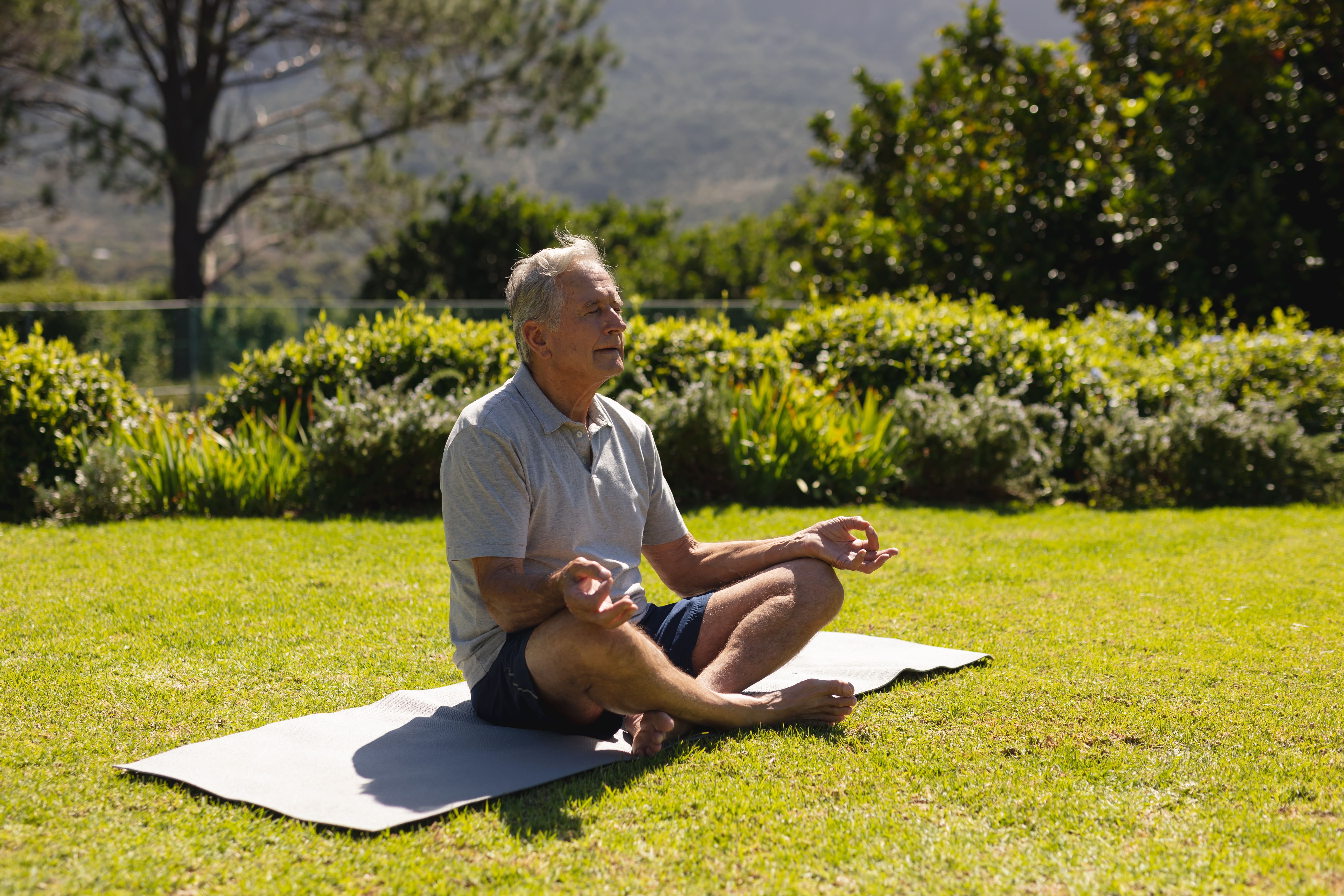 Senior doing yoga outdoors